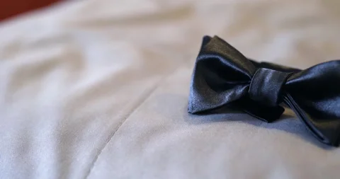 Black bow tie on light fabric with soft neutral lighting Vídeo Stock 336468974
