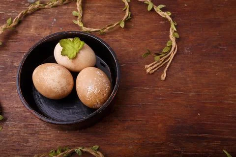 Black bowl with brown colored Easter eggs on rustic background. Spring, Easter Stock Photos