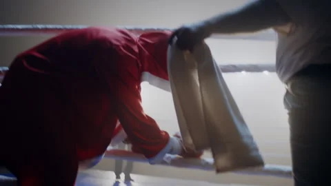 Black boxer in red robe approaching the ring with his opponent in it Stock Footage 282985306