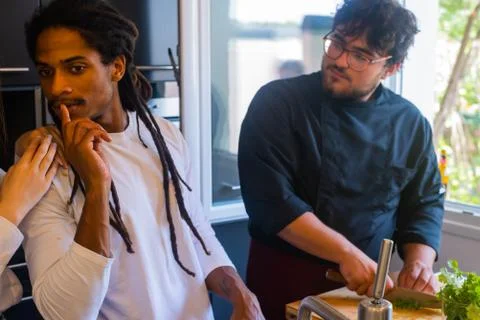 Black boy with dreadlocks with an expression of listening with a cook is cutt Stock Photos