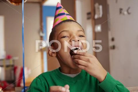 Black Boy Eating Cake At Party