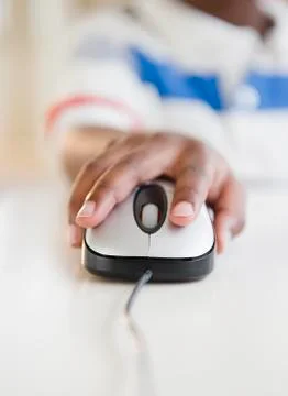 Black boy using computer mouse 스톡 사진