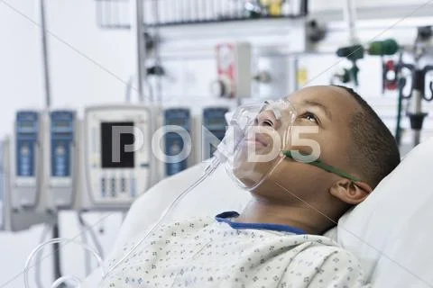 Black Boy Wearing Oxygen Mask In Hospital Bed