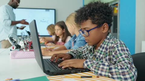 Black Boy Writing Computer Program for Electric Robot at Kids Tech Club Stock Footage 244349195