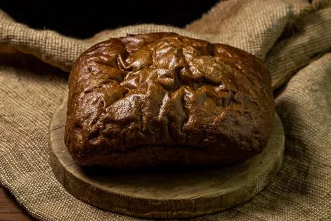 Black bread on a black background. Borodino bread. Homemade baking. Stock Photos