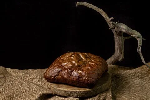Black bread on a black background. Borodino bread. Homemade baking. Stock Photos