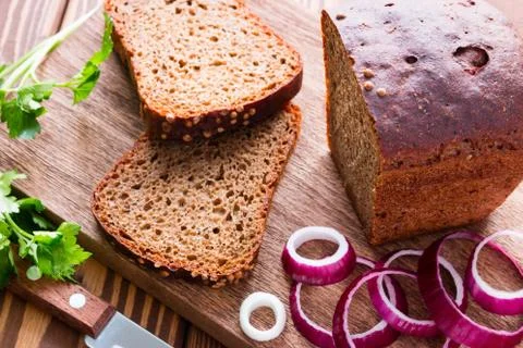 Black bread with bran and red onion and parsley selective focus Stock Photos