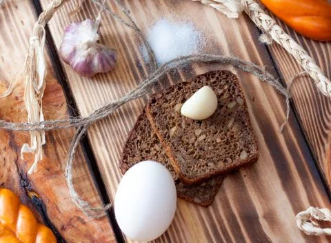 Black bread with garlic and egg on a wooden background Stock Photos