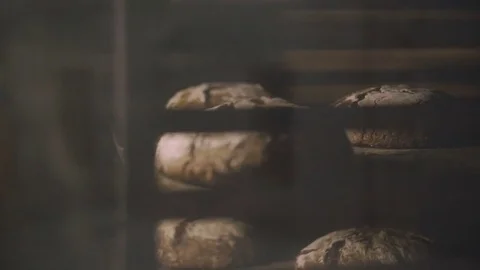 Black bread is processed by heat in the oven Stock Footage 76880966