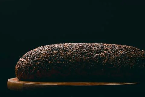 Black bread with seeds on dark background Stock Photos