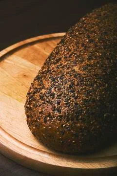Black bread with seeds on dark background Stock Photos