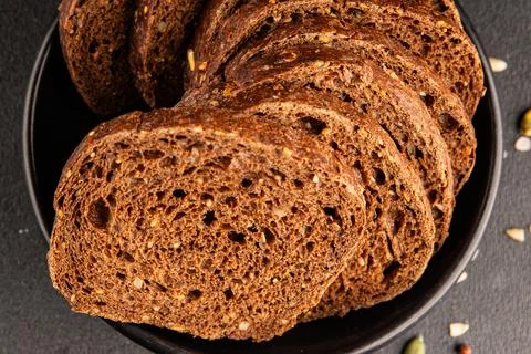 Black bread whole-grain rye flour slices of dark bread healthy eating delic.. Stock Photos