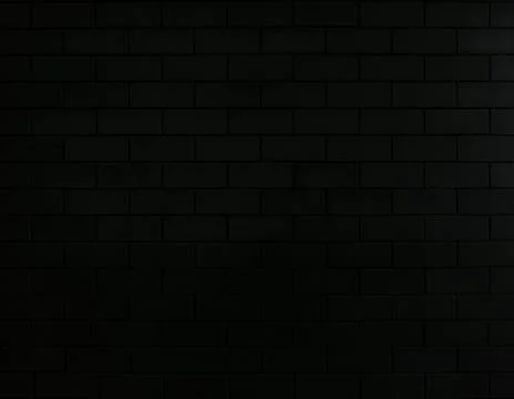 Black brick wall background in dark . Empty interior wall with light and shad Stock Photos