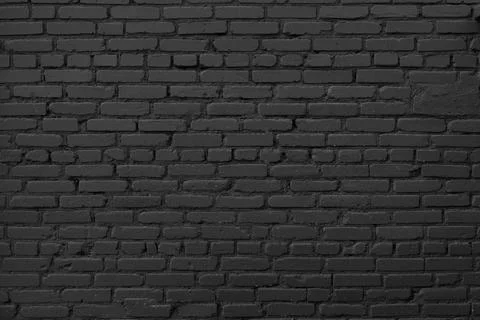 Black brick wall background. Dark brickwork. Copy space. Stock Photos