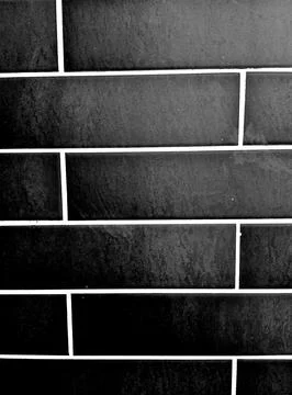 Black brick wall background with white grout lines texture Stock Photos