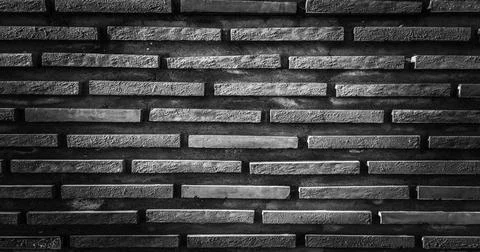 Black brick wall, dark background for design. Part of black painted brick ... Foto stock