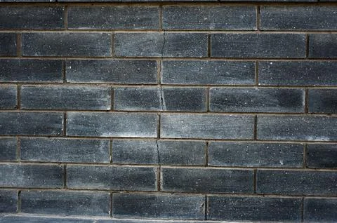 Black brick wall texture. Aged stone block masonry. Dark gloomy background Foto stock