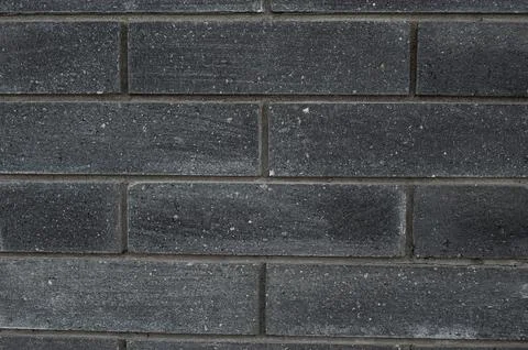 Black brick wall texture. Aged stone block masonry. Dark gloomy background Stock Photos