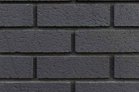 Black brick wall texture background close-up. Stock Photos