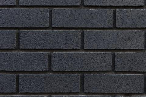 Black brick wall texture background close-up. Stock Photos
