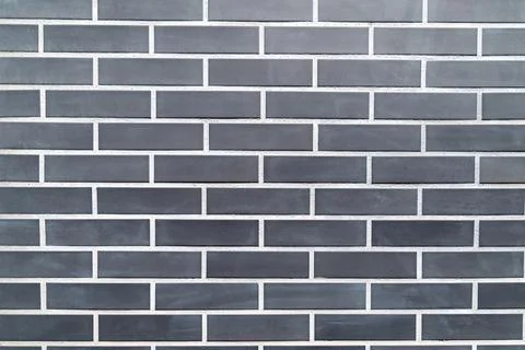 Black brick wall with uniform rectangular pattern Stock Photos