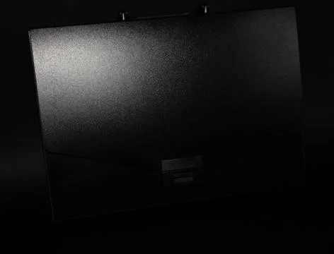 Black briefcase on a black background Stock Photos