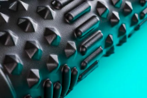 Black bumpy foam massage roller, body roller on blue background. F 写真素材