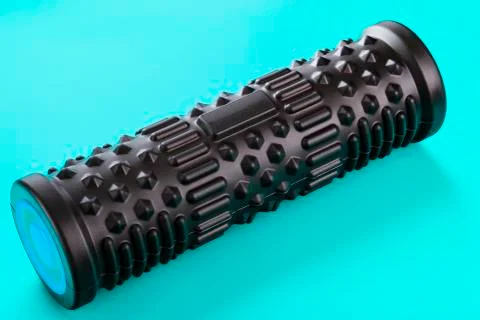 Black bumpy foam massage roller, body roller on blue background. F 写真素材