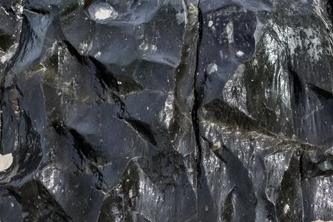 Black bumpy shiny stone, Wavy smooth texture 스톡 사진