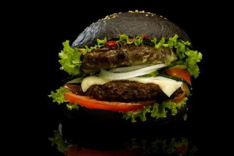 Black burger on a black background Stock Photos