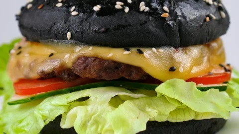 Black burger, close-up view, served in restaurant Stock Footage 87790752