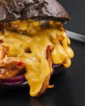 Black burger with pulled pork closeup Stock Photos