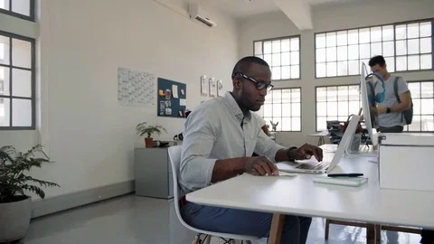 Black businesman working in shared work space Stock Footage 71631439