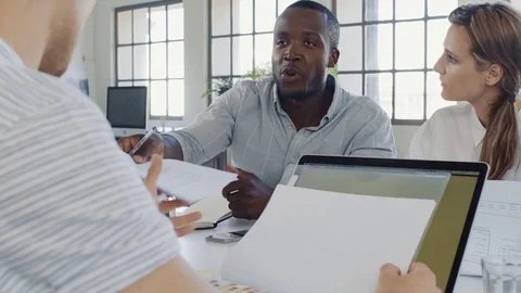 Black businessman handing over documents in meeting Stock Footage 73223333