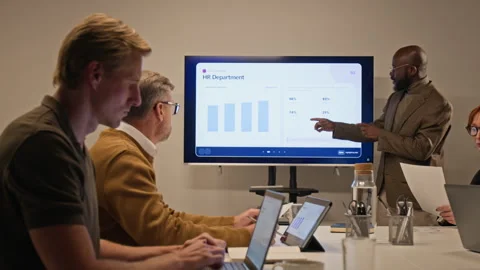 Black Businessman Presenting Data on Screen to Colleagues Stock Footage 347653573