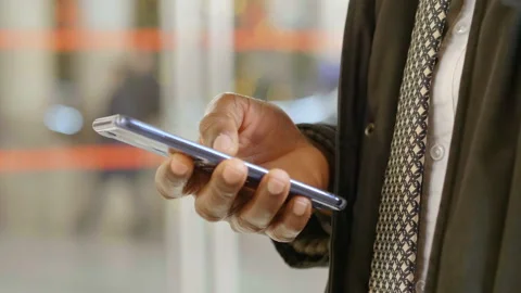 Black businessman' s hand checking his emails on the mobile phone - outdoors Video stock 131982272