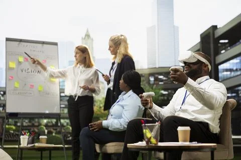 Black businessman testing virtual reality headset and controllers Stock Photos