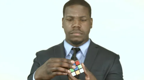 Black businessman trying to solve a cube puzzle (2) Stock Footage 61651736