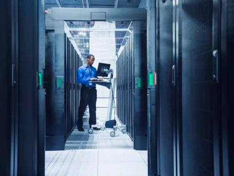 Black businessman using computer in server room Stock Photos