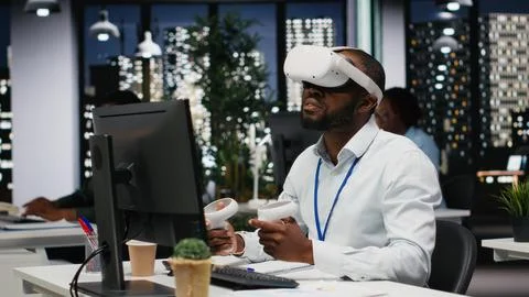 Black businessman using vr headset and gadgets to draft a project plan Stockfoto's