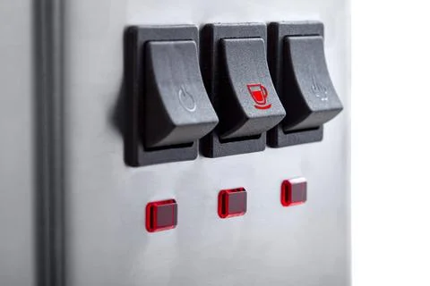 Black button for making coffee with a red icon cup, close-up of the panel. Stock Photos