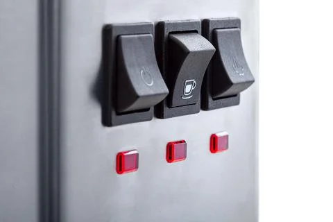 Black button for making coffee with a white cup icon, close-up. Stock Photos