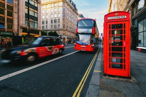 Black cab, red double decker bus and phone cabin at The Strand in London Stock Photos
