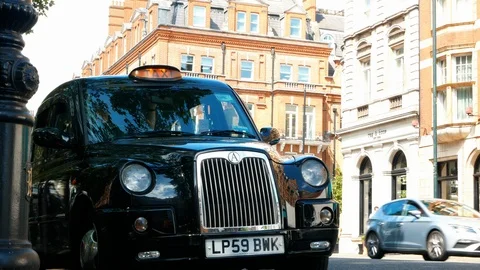 Black cabs in taxi rank on Sloane Square in Chelsea, London. Stock Footage