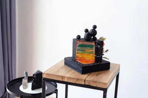 Black Cake Cut with Colored Layers Stock Photos