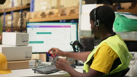 Black call center operator assisting a client with order mix up problems Stock Footage 315716530