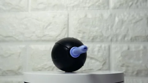 Black camera blower with blue nozzle rotating on a white surface, highlight.. Stock Footage 297152129