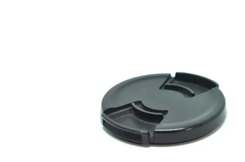 Black camera len cap on white background. Stock Photos