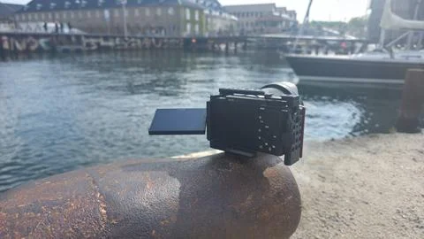 Black camera rests on rusted pier Fotos Stock