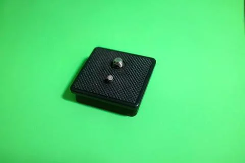 Black camera shutter button on green background Stock Photos
